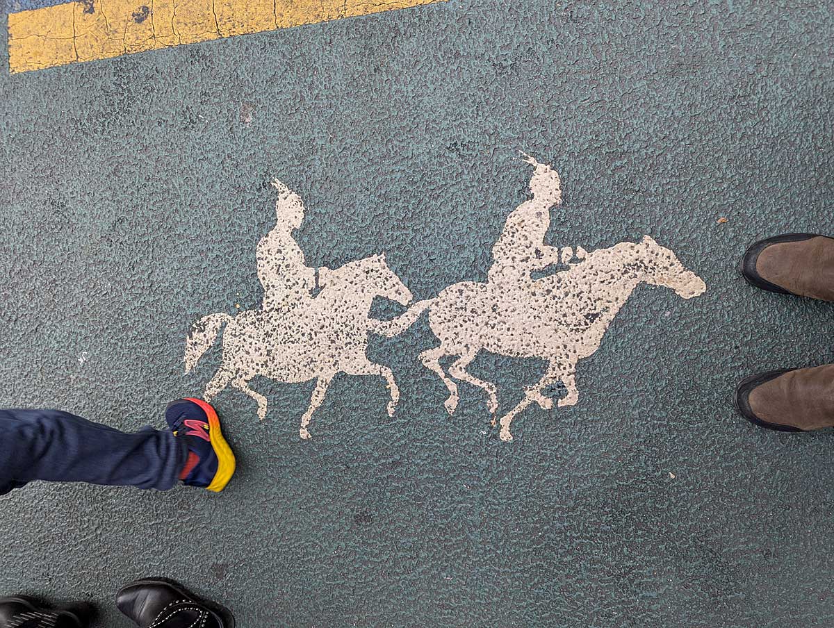 Painting of Mongolian horsemen on the sidewalk